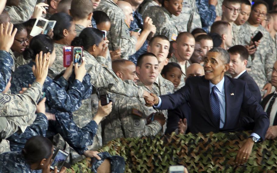 Then-President Barack Obama shakes a service member's hand following a speech at Yongsan Garrison in Seoul, South Korea, April 26, 2014.