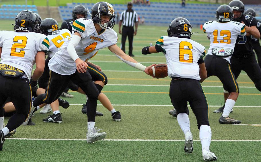 Robert D. Edgren's Parker Kuns hands off to running back P.J. Lorenzo, who rushed for a touchdown for the Eagles.