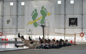 Special Warfare trainees perform flutter kicks at Joint Base San Antonio-Lackland, Texas, Oct. 21, 2021. The training wing will finish facilities next year that will include mixed-sex dorms and bathrooms, which Air Force officials say will foster better unit integration. 
