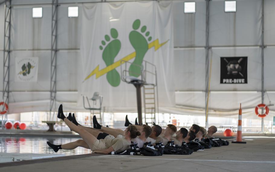 Special Warfare trainees perform flutter kicks at Joint Base San Antonio-Lackland, Texas, Oct. 21, 2021. The training wing will finish facilities next year that will include mixed-sex dorms and bathrooms, which Air Force officials say will foster better unit integration. 