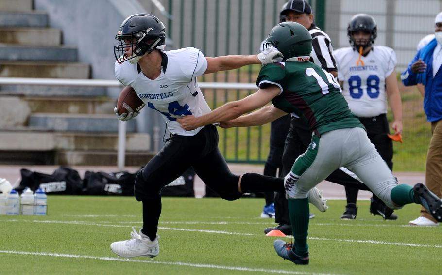 Jaiden Workman of Hohenfels keeps AFNORTH’s Seamus Corrigan at a distance as he rushes for a big gain in the Tigers’ 76-28 loss to the Lions in a Division III game played at Kaiserslautern High School, Saturday, Sept. 11, 2021.