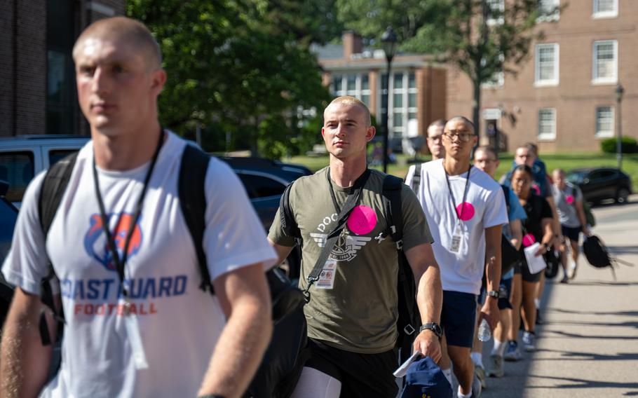 Coast Guard Academy cadets walk in a line