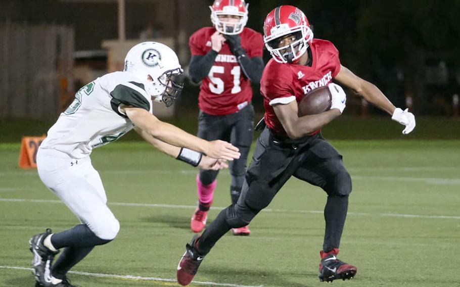 Nile C. Kinnick running back Wendell Harrison looks for running room against Kubasaki's Ian Lyons.