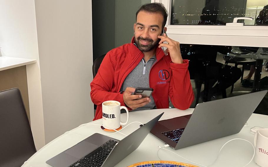 Safi Rauf, a U.S. Navy corpsman, takes a call June 23, 2022, as part of efforts to send aid to Afghanistan after a devastating earthquake there. Rauf is part of a group of American veterans raising funds and providing supplies to Afghans in the affected areas.