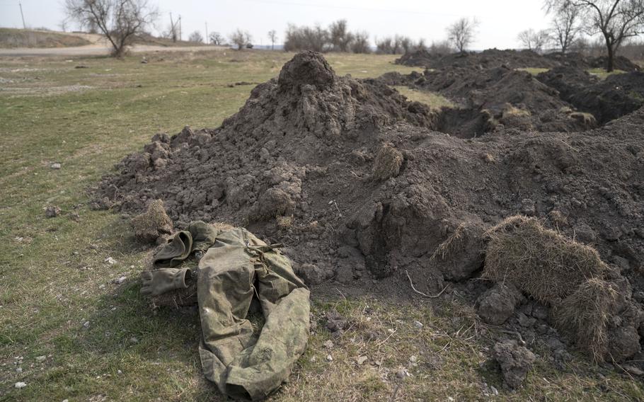 A discarded military uniform remains by trenches that Russian soldiers dug to defend their position outside Vynohradivka, Ukraine, in late March. 