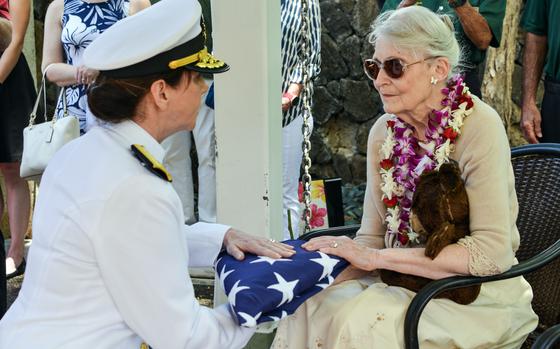 Barbara Canavan, daughter of Navy Cmdr. Frederick Schrader, is given a U.S. flag during his interment ceremony at the National Memorial Cemetery of the Pacific in Honolulu, Hawaii, April 13, 2023.

