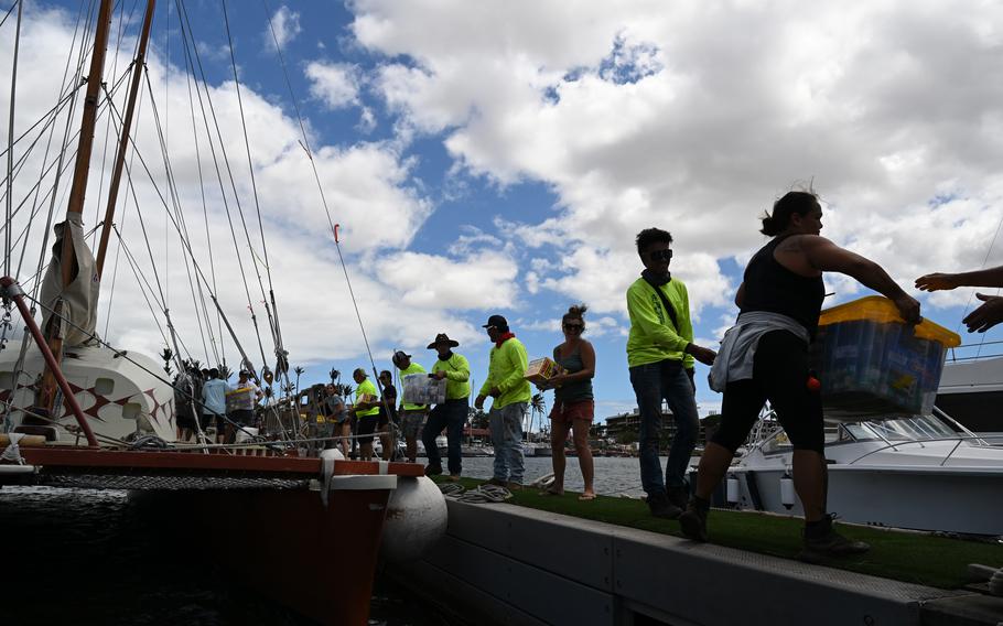 Members of the Hikianalia canoe club unload supplies from a boat at Maalaea Harbor on Monday, Aug. 14, 2023.