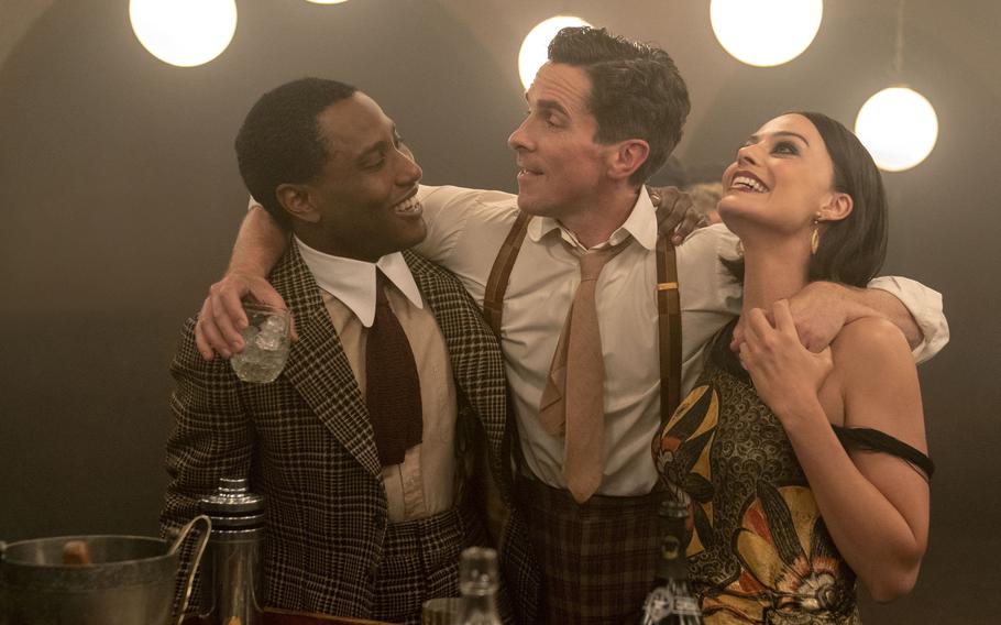 From left, John David Washington, Christian Bale and Margot Robbie are part of the ensemble cast of “Amsterdam.”