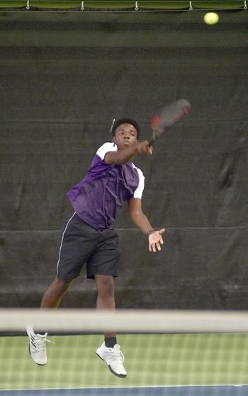 Bahrain’s Ja’Cori Thomas serves during a boys doubles match Thursday during the DODEA European tennis championships at the T2 Sports Health Club in Wiesbaden, Germany. He and teammate Matthew Mendoza faced Kaiserslautern’s Jacob Gerber and Jace Martin.