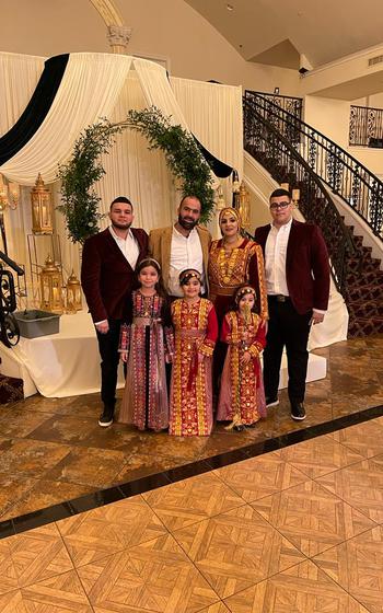 Tawfic Abdel Jabbar, right, poses with his family during a cousin’s wedding in New Orleans in January 2022. 