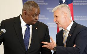 U.S. Secretary of Defense Lloyd Austin, left, and Latvian Minister of Defence Artis Pabriks talk during their press conference in Riga, Latvia, Wednesday, Aug. 10, 2022. 