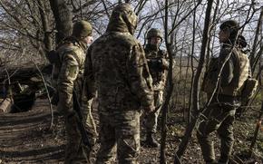Victor Dadak, center, a deputy battalion commander, speaks with soldiers in the woods at a military position in the Zaporizhzhia region on Nov. 30. MUST CREDIT: Photo for The Washington Post by Heidi Levine.