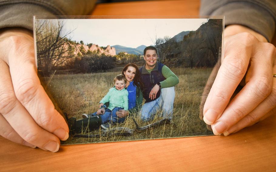 Lorna Illerbrunn holds a picture of her husband, Garrett, her son Tucker and herself while at a military hospital in Landstuhl, Germany, on Jan. 8, 2024. Chief Warrant Officer 4 Garrett Illerbrunn was transported last week from Landstuhl Regional Medical Center to Homburg, where he will have brain surgery Tuesday. He was one of three U.S. soldiers injured in a drone attack in Irbil, Iraq, on Dec. 25, 2023.