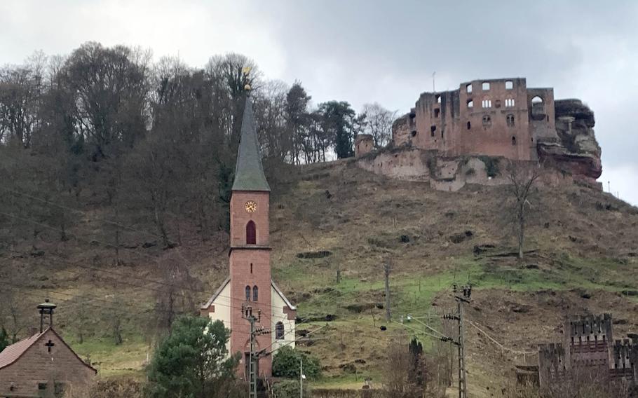 The Protestant church and the ruins of Frankenstein Castle tower over the German town of the same name, Jan. 23, 2022.