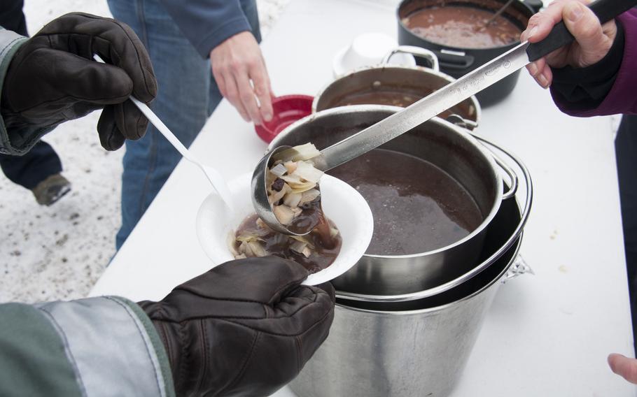 Narwhal soup is dished out to the workers at Thule Air Base during a weekend of demonstrations of Inuit life. Seal stew was also available, and one could purchase slabs of beluga and musk ox.