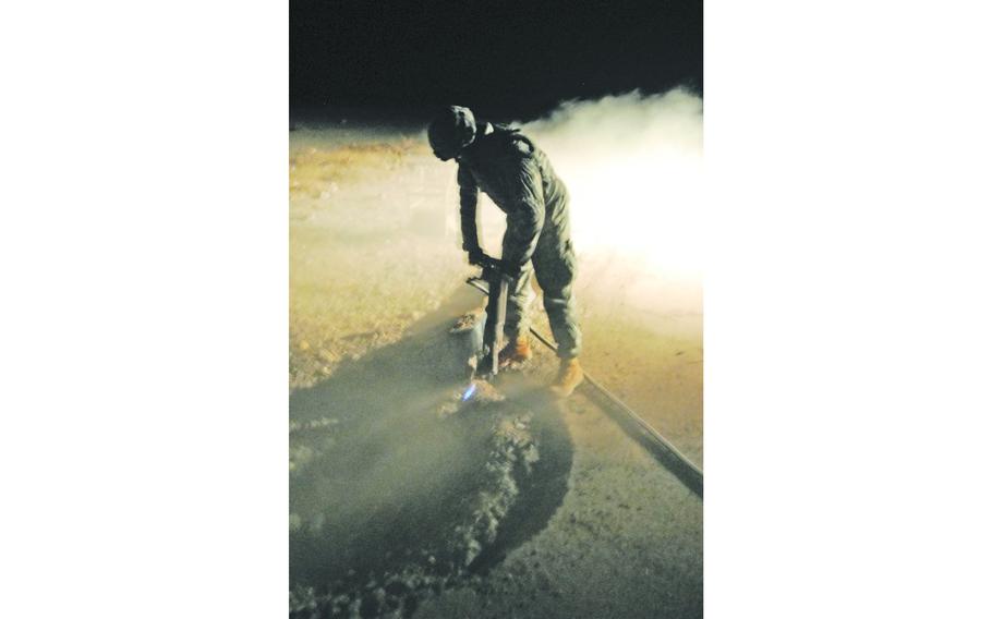 A soldier with 1st Platoon, 60th Engineering Company, which is attached to the 19th Engineer Battalion, uses a jackhammer to shape a roadside bomb crater before it is filled with concrete on Highway One, near Tikrit, Iraq. If left unrepaired, the craters provide hiding places for explosives and driving hazards for motor vehicles.