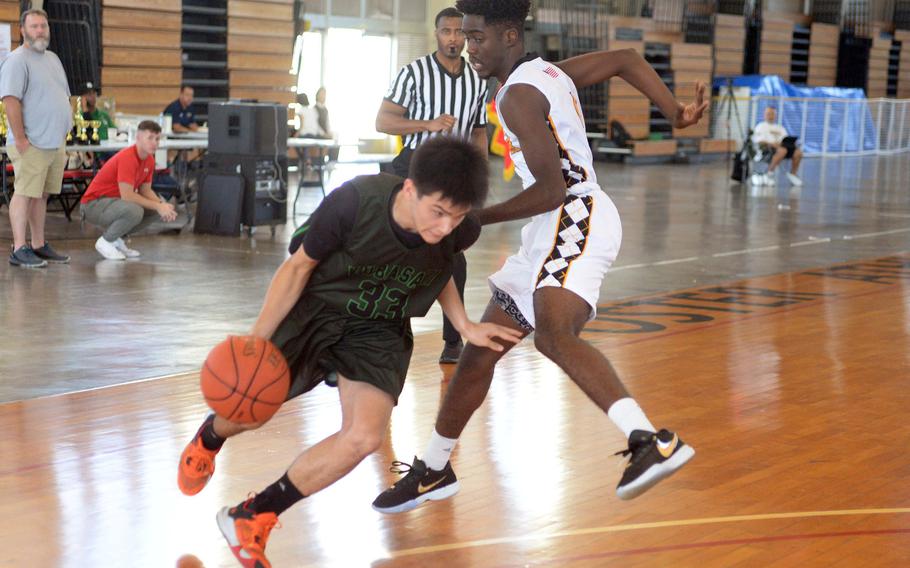 Kubasaki's Ryan Hater drives against Kadena's Cedrick Dorelien during Sunday's semifinal, which the Panthers won 56-35. 