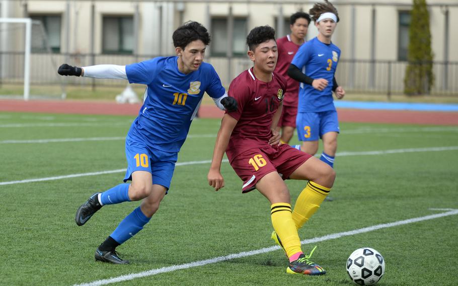 Yokota's Kai Patton and Matthew C. Perry's Ren Spinosi chase the ball during Saturday's DODEA-Japan boys soccer match. The Panthers won 1-0.
