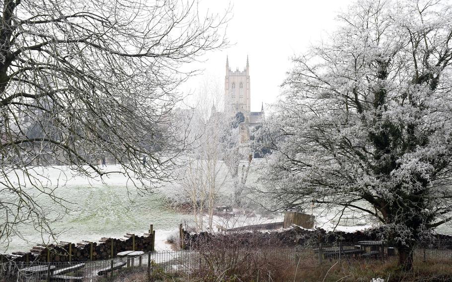 The Saint Edmundsbury Cathedral as seen from across the River Lark. Originally built in the 11th century, the church has been rebuilt multiple times and officially became a cathedral in 1914.