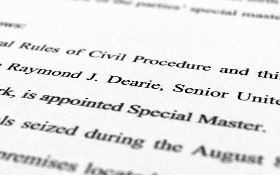 A page from the order by U.S. District Judge Aileen Cannon naming Raymond Dearie as special master to serve as an independent arbiter and to review records seized during the FBI search of former President Donald Trump's Mar-a-Lago estate, is photographed Thursday, Sept. 15, 2022.
