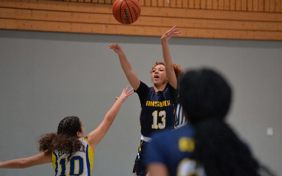 Ansbach’s Grace Robinson gets off one of her 3-pointers as Sigonella’s Charlize Caro defends. Sigonella beat Ansbach 41-18 in a Division III game at the DODEA-Europe basketball championships in Baumholder, Germany, Feb. 16, 2023. 