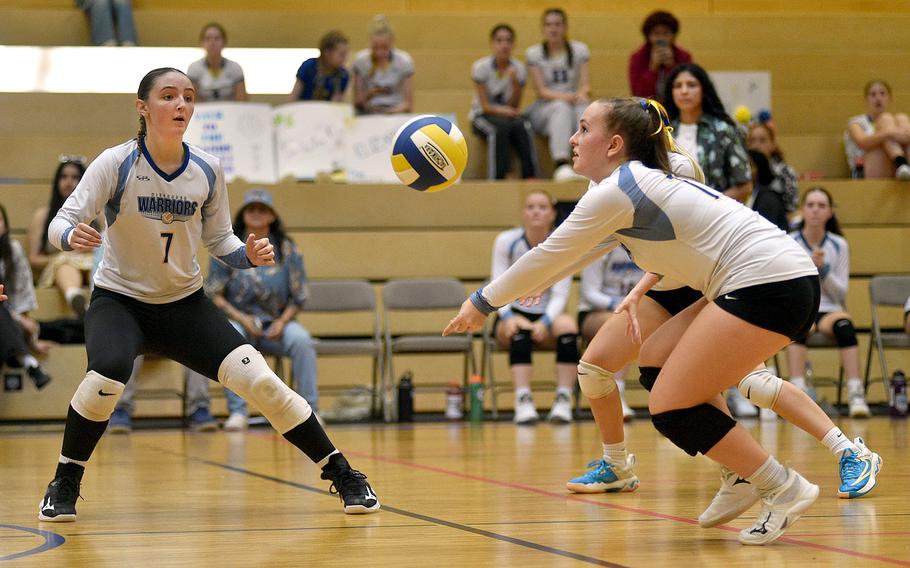 Warrior Bailey Foulk bumps the ball during a match against Stuttgart on Sept. 9, 2023, at Wiesbaden High School in Wiesbaden, Germany. Teammate Audrey Garrison, left, watches.