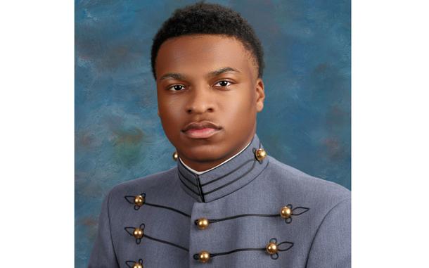 A portrait of a U.S. Military Academy cadet posing in gray dress uniform in front of a blue background.