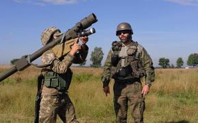 A Polish instructor assigned to the 21st Podhale Riflemen Brigade instructs a Ukrainian Soldier how to fire the 9K333 "Verba" portable air defense missile system, Aug. 9, at the International Peacekeeping and Security Center in Ukraine. The Polish forces recently partnered with the American Army to train Ukrainian Soldiers at the Joint Multinational Training Group-Ukraine. JMTG-U is an example of multinational partners working together to help build the training capacity of the Ukrainian land forces. (Photo courtesy of Polish Forces)