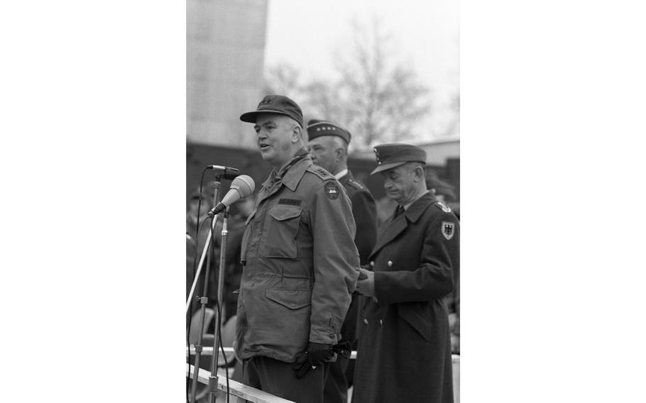 Lt. Gen. Donald V. Bennett, VII Corps commander, addresses the arriving Reforger I troops, with Gen. Howell M. Estes Jr. and German Lt. Gen. K. W. Thilo behind him. 