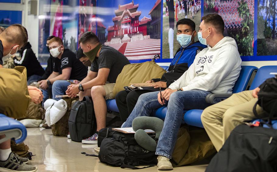 Marines wait inside the passenger terminal at Kadena Air Base, Okinawa, June 6, 2020.