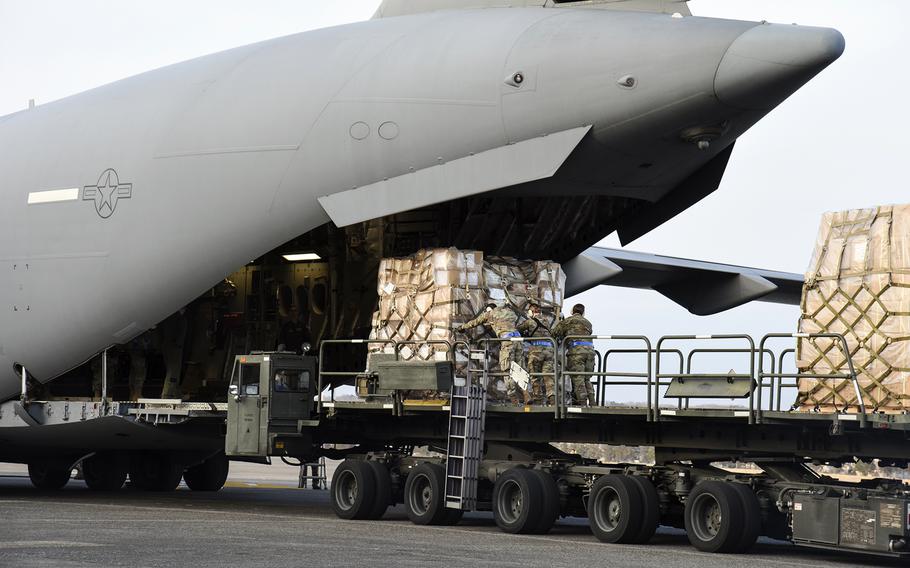 Japanese military supplies bound for Ukraine are loaded onto an Air Force C-17 Globemaster III at Yokota Air Base, Japan, Wednesday, March 16, 2022.