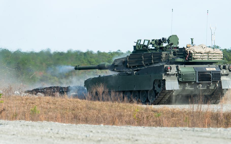 An M1A2 Abrams tank fires at Fort Moore, Ga., on Dec. 5, 2023, during a shoot by Iraq war veteran Jay Tenison, who served as a tanker from 2004 to 2008. Tenison was diagnosed with terminal stomach cancer in 2022 and sought to shoot a tank one last time as his dying wish. 