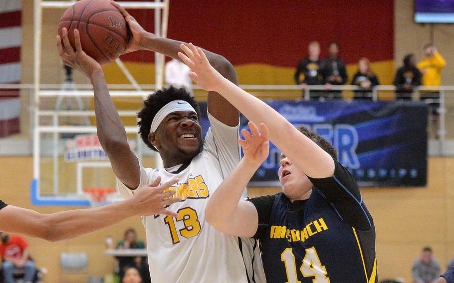 Chandler Piggé of Baumholder fights his way to the basket against Dustin Martin of Ansbach as  Baumholder won its third title in a row with a 50-43 win in the boys Division III championship game at the DODEA-Europe basketball finals in Wiesbaden, Germany,  Feb. 22, 2020. 