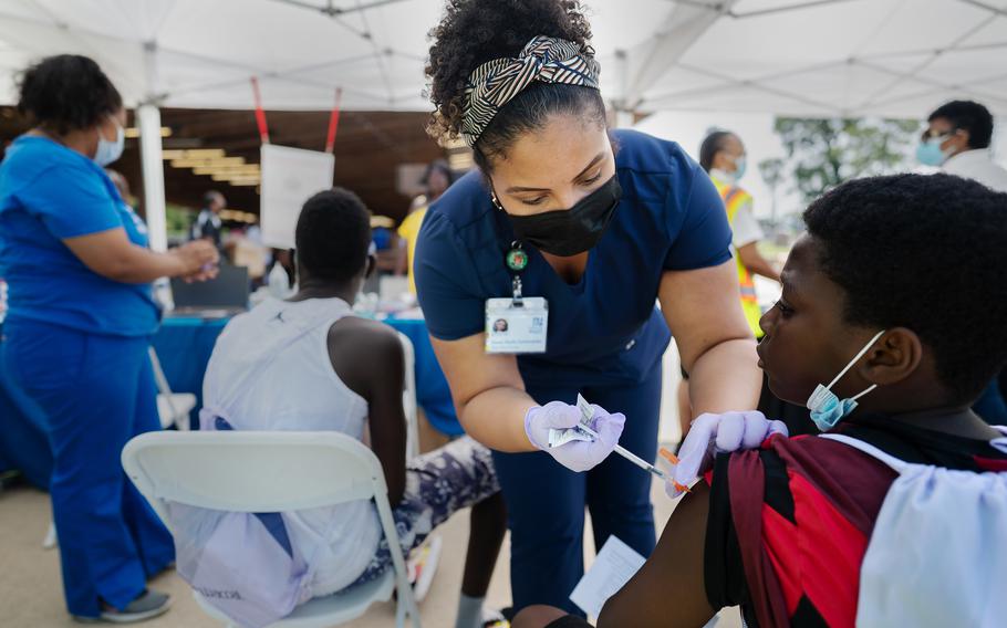 Vaccines have reduced the virus’s worst effects. Community of Hope clinical nurse manager Imani Mark injects Ezekiel Akinyeni with a shot July 31, 2021, in D.C.