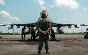 Airman 1st Class Cole Muder prepares to marshal an F-16 Fighting Falcon during exercise Cope Thunder at Clark Air Base, Philippines, May 11, 2023. 