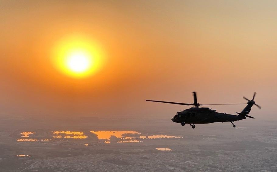 A U.S. Army UH-60 Black Hawk helicopter flies over Iraq in 2020. In a move that could help the Army retain pilots, the service is making it easier for retired warrant officers to serve in the Reserve and Guard, the Army said in a statement July 13, 2021. 