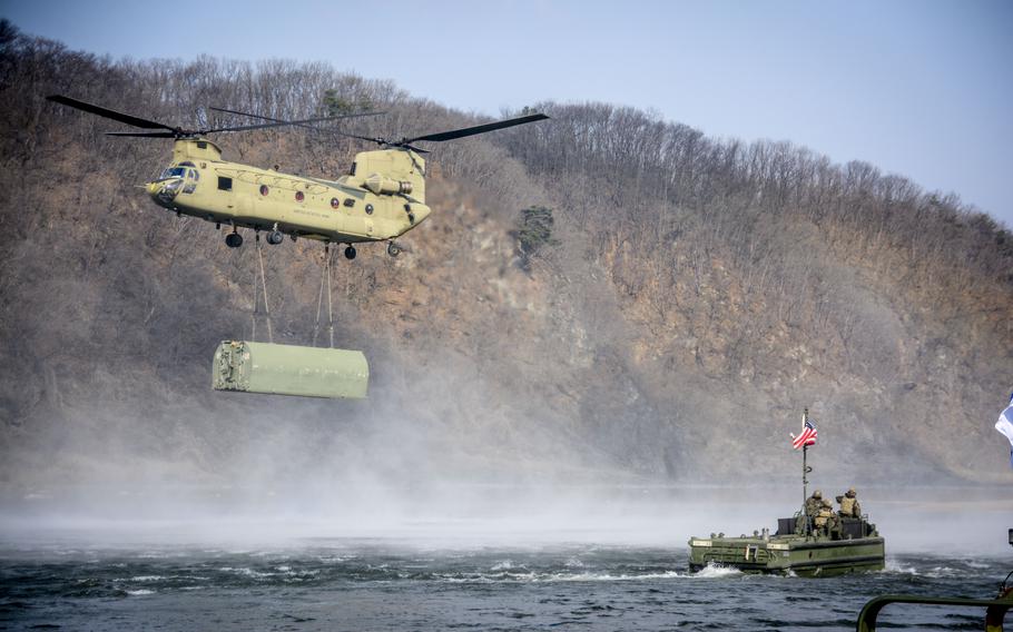 A CH-47 Chinook helicopter of the 3rd General Support Aviation Battalion, 2nd Combat Aviation Brigade, delivers a bridge component to U.S. Army engineers for assembly during practice for a wet gap crossing at the Imjin River, South Korea, March 20, 2024. 