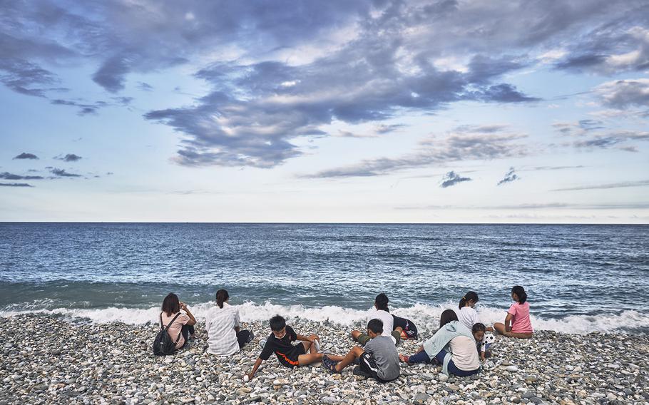 A family relaxes in August on a beach at Hualien, which looks out to the Pacific Ocean. 