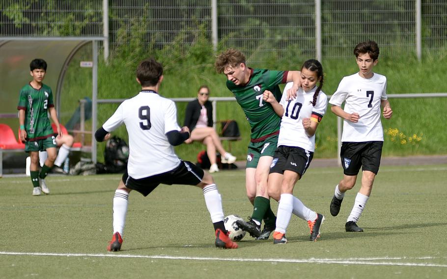 AFNORTH senior Santiago Aponte holds off Hohenfels midfielder Taryn Olson, center right, during the second day of pool-play action at the 2025 Division III DODEA European championships on May 20, 2025, at Rothenborn Stadion in Landstuhl, Germany. Olson's Tiger teammate, Aaden Lopez, right, watches the action.