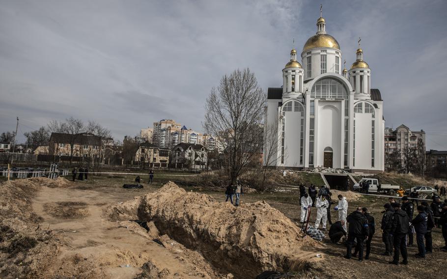 Bodies of civilians are exhumed from a mass grave in Bucha, Ukraine, on the outskirts of Kyiv, on April 8.