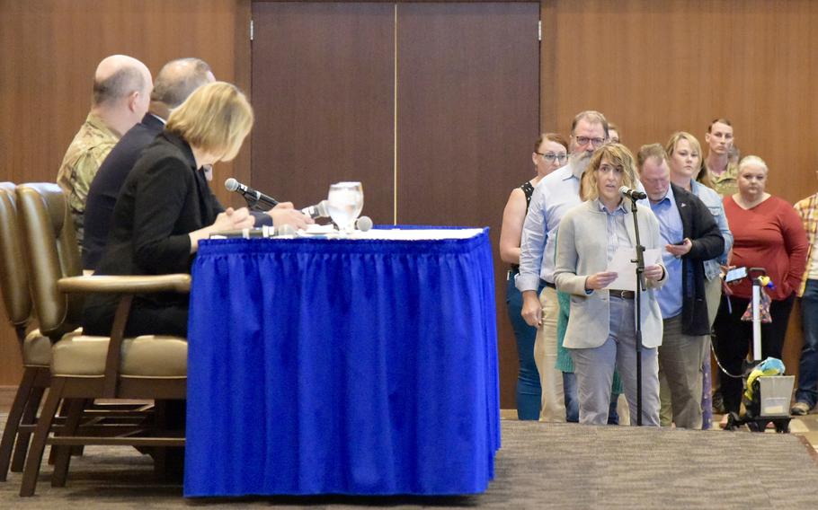 A woman asks a question about civilians' access to health care during a town hall meeting at Kadena Air Base, Okinawa, Feb. 1, 2023. 