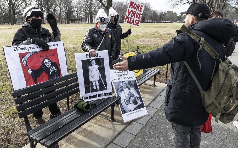 Pro-vaccine counter-protesters argue with a participant in a rally held in opposition to vaccine mandates, near the National World War II Memorial in Washington, D.C., Jan. 23, 2022.