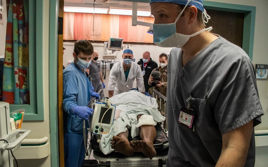 Army Maj. Benjamin Clark leads a patient and other American and German medics to the operating room during a mass casualty response drill at Landstuhl Regional Medical Center, Germany, Thursday, March 10, 2022. 