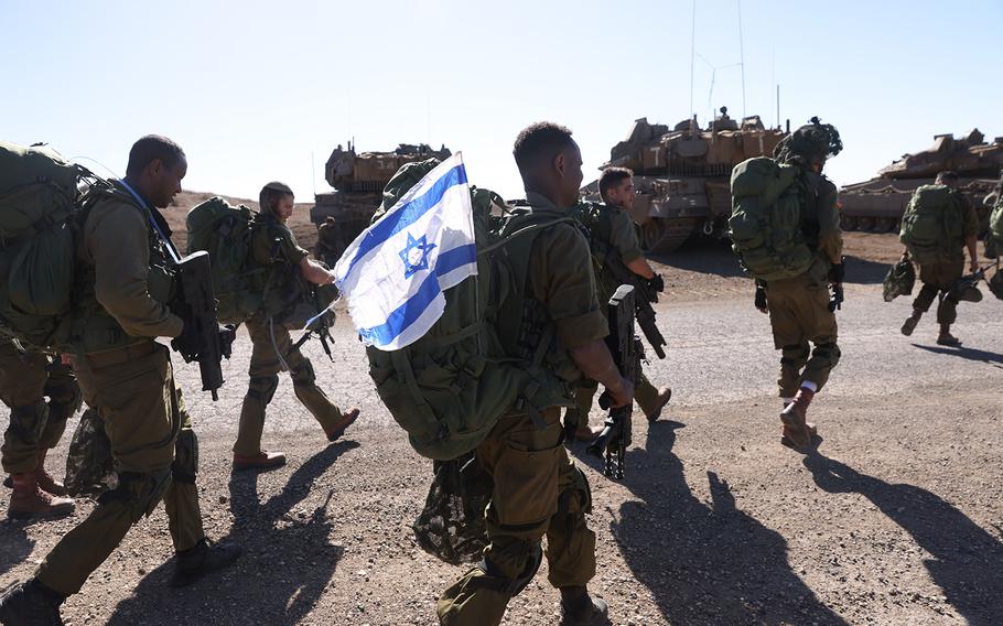 Israeli soldiers walk during a drill in the annexed Golan Heights on Nov. 9, 2023, amid increasing cross-border tensions between Hezbollah and Israel as fighting continues in the south with Hamas militants in the Gaza Strip. 