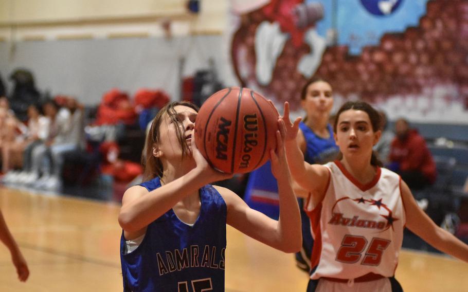 Rota's Jourdan Timmons puts up a shot before Aviano's Clara Young can get to her in the Saints' 30-16 victory over the Admirals on Friday, Dec. 9, 2022 in Aviano, Italy.