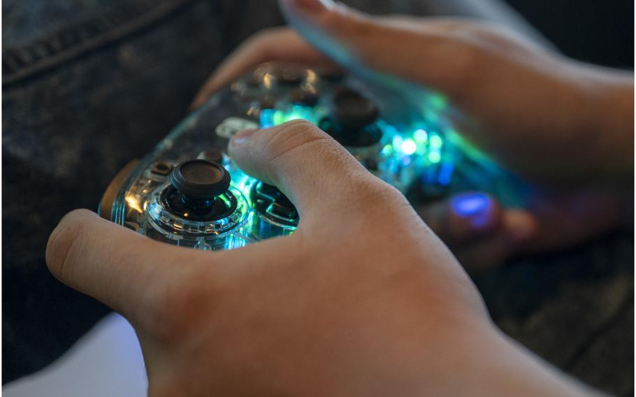 A closeup of hands using a video game controller.