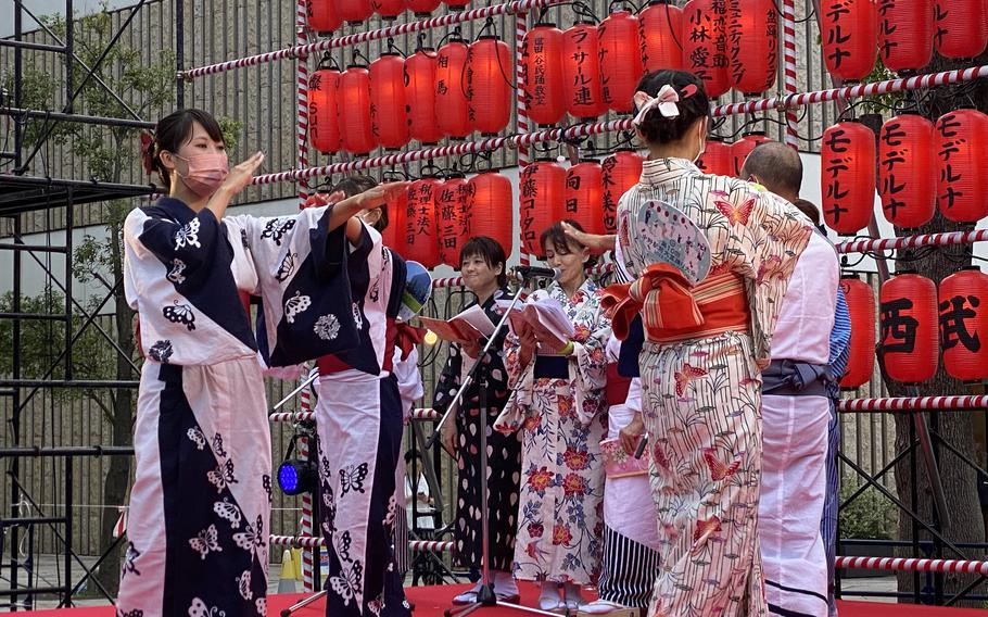 Bon Odori dancers wear masks during a festival in Nakano, Tokyo, Saturday, Aug. 6, 2022.
