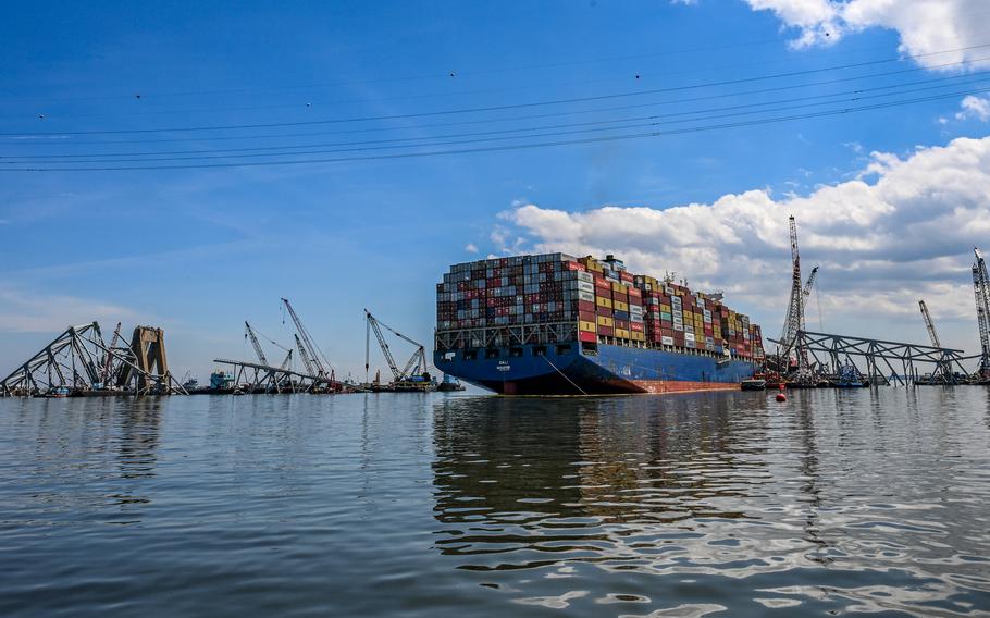 Crane barges surround the container ship Dali and the wreckage of the Francis Scott Key Bridge two weeks after the catastrophic collapse.