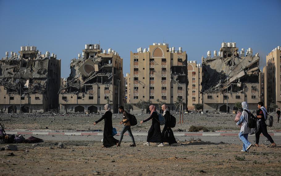 Residents leave the Hamad Towers area after Israeli attacks in Khan Younis on Saturday, Dec. 2, 2023.
