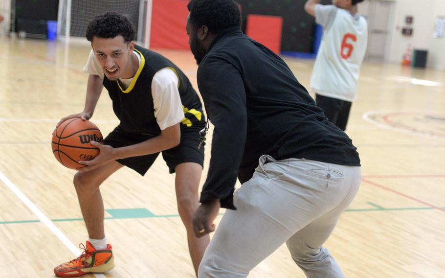 Kadena boys basketball coach Antiwon Tucker works with senior Derek Santiago on a creating-space drill. Santiago transferred to Kadena from Gulf Breeze, Fla.